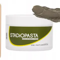 Słoiczek zielonej pasty z zieloną glinką, drewniana szpatułka i próbka pasty.